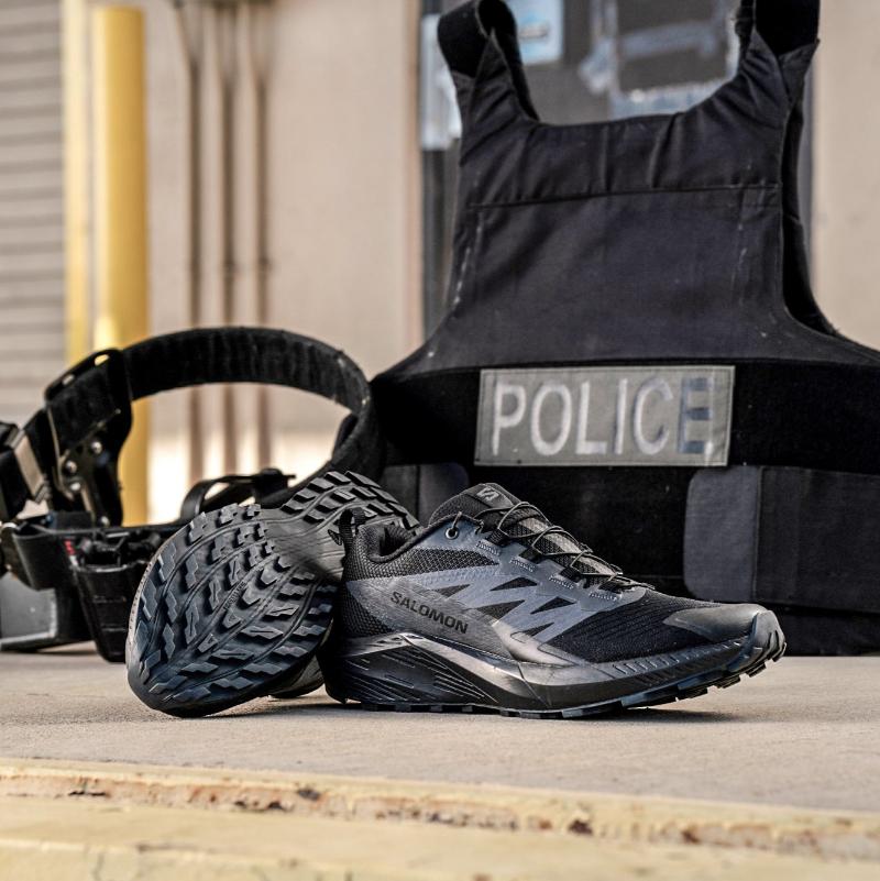 Lifestyle photo of the Salomon Trail Running Shoe in Black being worn during tactical training and field movement. Showcases the lightweight, slip-resistant design ideal for law enforcement, EMS, and outdoor professionals. Built for speed, comfort, and traction on mixed terrain, this hybrid trail running and duty shoe transitions seamlessly from range to street.