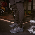 Lifestyle image showing the Salomon Trail Running Shoe in Black being used during a gym workout, highlighting its stability, traction, and comfort for tactical fitness and training. Perfect hybrid shoe for law enforcement, military, and EMS professionals who need durable, slip-resistant footwear for gym sessions, conditioning drills, and cross-training. Built for agility and all-day performance.