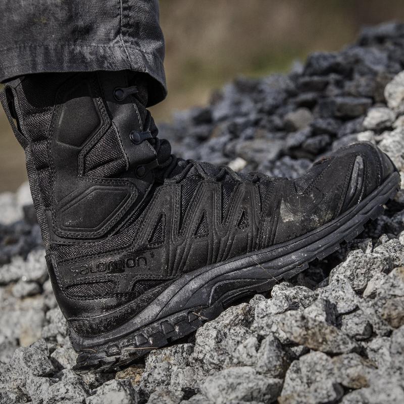 Salomon XA Forces 8 Inch GTX boots moving across rocky ground, demonstrating grip, stability, and durability in challenging environments.