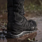 Salomon XA Forces 8 Inch GTX boots standing in wet terrain, highlighting GORE-TEX waterproof protection and durable field-ready construction.