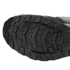 Bottom view of the Black Salomon XA Forces Mid featuring an aggressive traction pattern for mixed terrain performance.