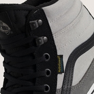 Close-up of a black and gray sneaker with a visible brand logo.