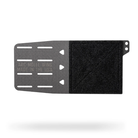 A black and dark gray split-panel mounting plate with a textured velcro-like black section on the right and a metal gray section on the left with cutouts and embossed text reading 'ARC-MOLLE WING MADE IN THE USA'.