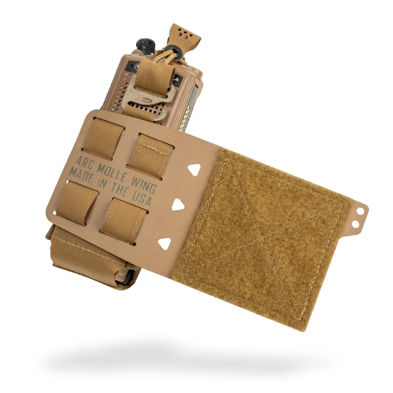 A tan tactical radio pouch with a flap closure and multiple hook-and-loop tabs, shown floating on a white background. The front of the pouch is printed with the text 'ARC MOLLE WING MADE IN THE USA'.