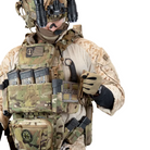 Operator wearing Shaw Concepts Shaw Shank V3 mounted on plate carrier, low profile fixed blade knife pouch secured along side wing of tactical armor setup, streamlined side mount carrier built for combat gear, military loadouts, and law enforcement duty applications made in the USA