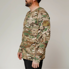 Side profile of tactical MultiCam range shirt showing loop patch panel on the bicep, ideal for ID or morale patches during range sessions or field use. Comes in both long and short sleeves.

