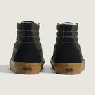 Pair of high-top sneakers with black and green color block design on a light background