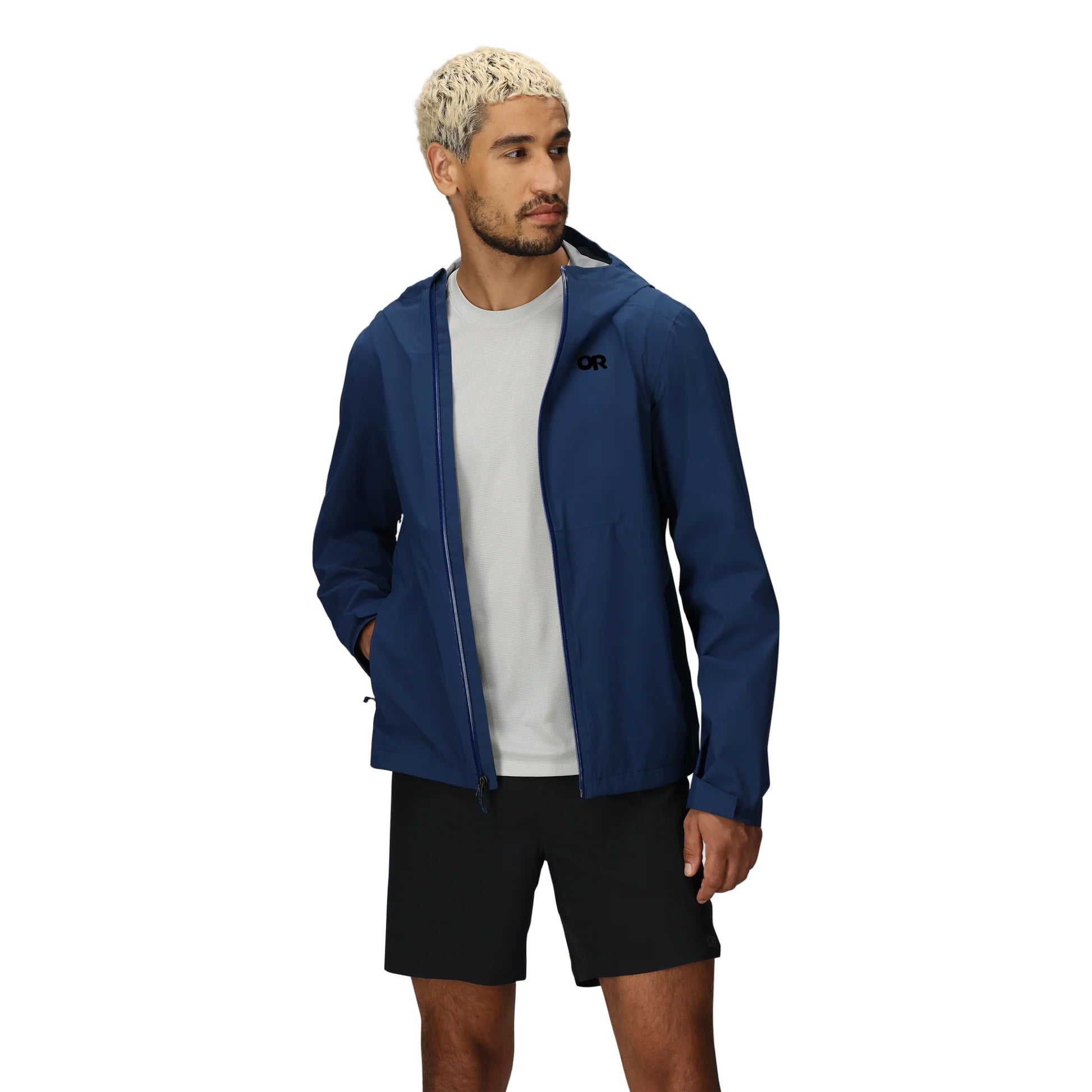 Outdoor Research Stratoburst Stretch Jacket in navy blue Cenote worn unzipped, revealing internal ventilation system and adjustable hem for active movement in wet weather