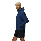 Three-quarter side angle of the Stratoburst Jacket in Solid Cenote colorway, featuring zippered hand pockets, pit zips, and stretch-fit silhouette for tactical performance