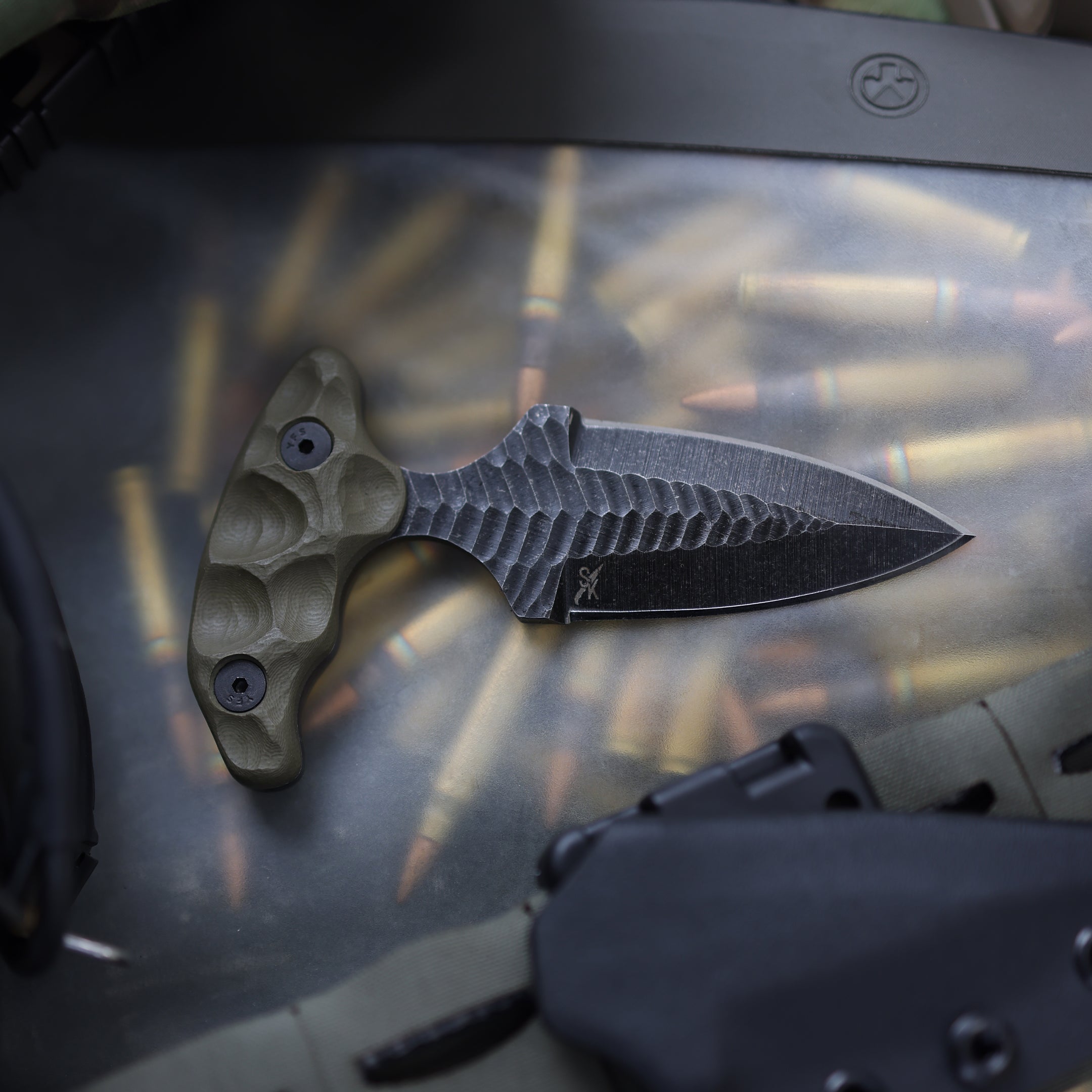 Tactical flat lay of Stroup SD1 push dagger tactical knife highlighting double edged 1095 high carbon steel blade details, compact fixed blade self defense knife for concealed carry EDC, close quarters combat, and tactical kit setup made in the USA