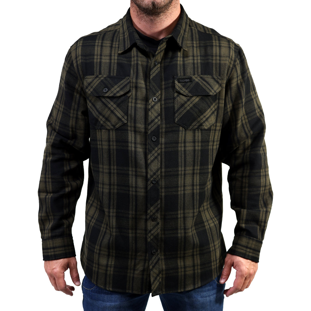 A man wearing a long-sleeve button-up plaid shirt in ranger green and black, paired with blue jeans, shown against a plain white background.