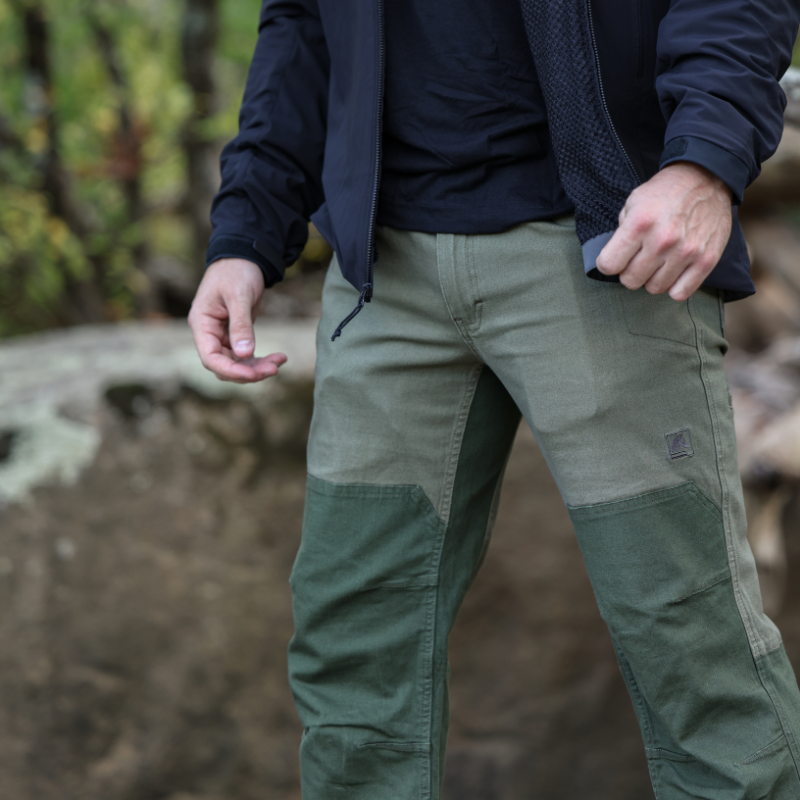 Model wearing olive green TD Braddock Tactical Pants showing workwear fit, heavy canvas construction, and reinforced tactical features in real-world use