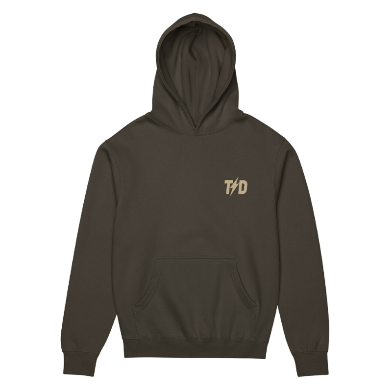 Washed black hoodie with a TD logo on the chest against a white background