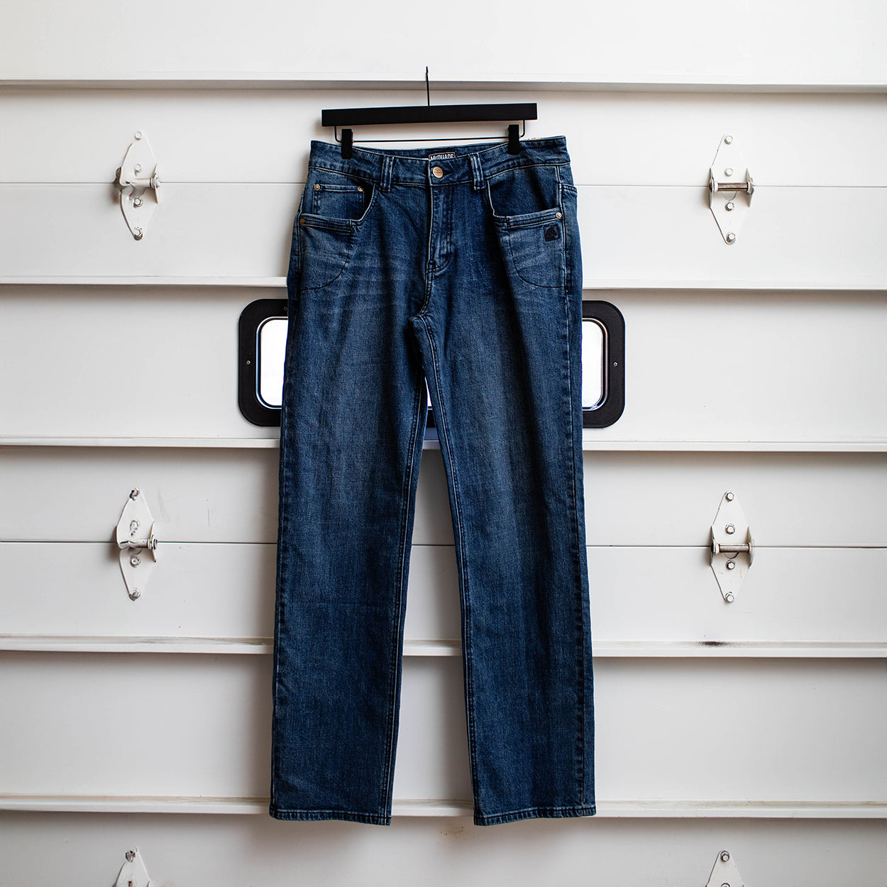 TD McQuade Tactical Jeans in the Marlboro mid blue wash shown hanging in the regular cut, highlighting the stretch tactical denim construction, ten pocket EDC layout, reinforced belt loops, and concealed carry friendly design for users searching for the best tactical jeans, CCW denim, and everyday carry pants.