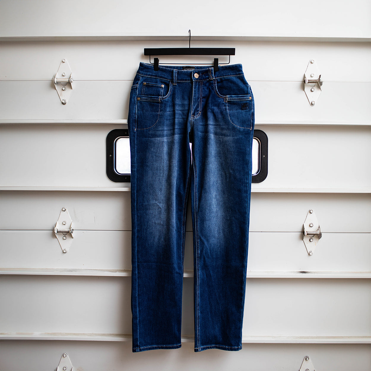 TD McQuade Tactical Jeans in the Vintage wash shown hanging in the regular cut, highlighting the durable stretch tactical denim, reinforced belt loops, AR mag compatible EDC pockets, and concealed carry optimized design for users searching for the best tactical jeans and everyday carry pants.