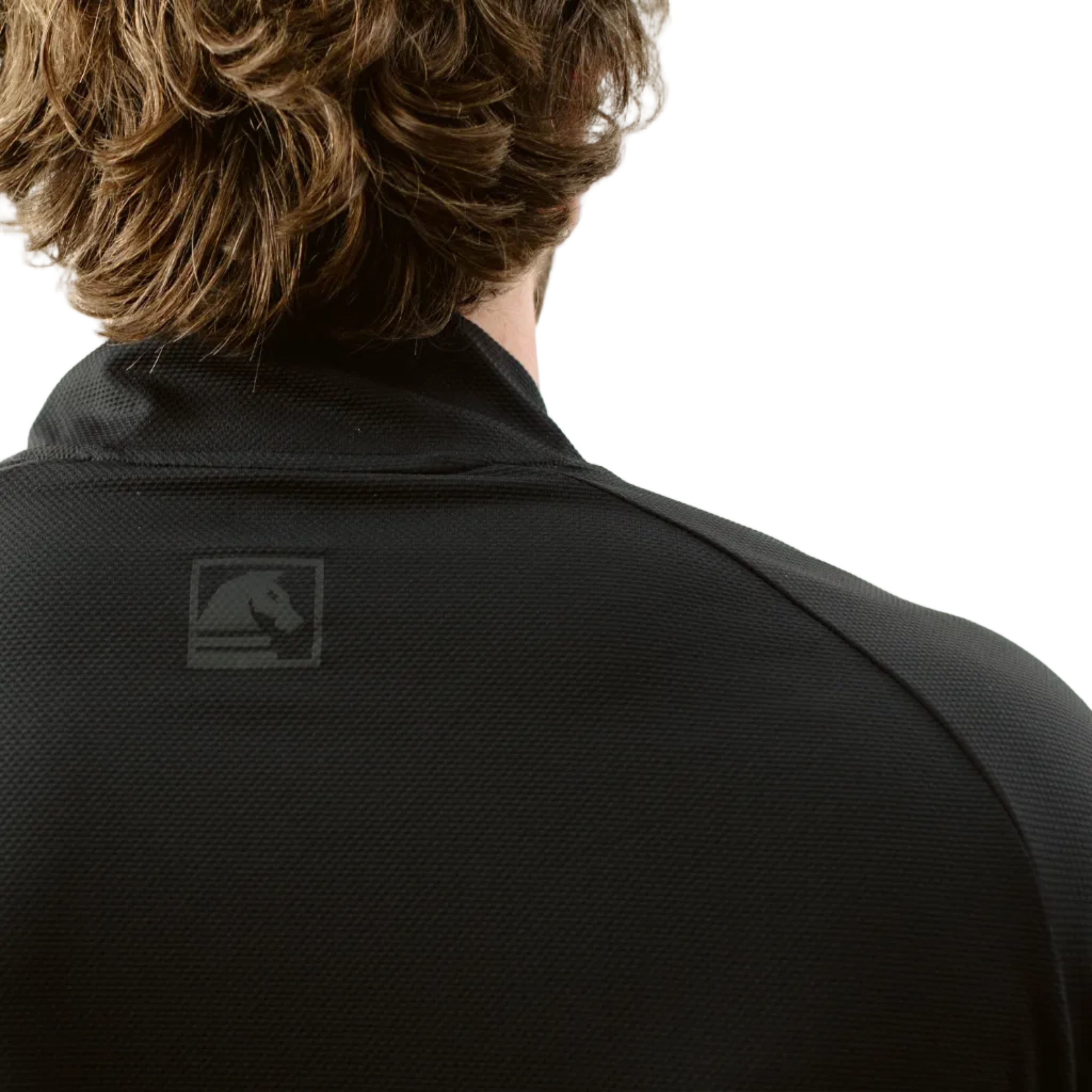 Close up of TD OSS Top Short Sleeve in Black showing back neck branding, wrapped shoulder seams, and raglan sleeve construction, lightweight tactical range shirt and combat base layer designed for hot weather training, operator use, and duty wear under plate carriers