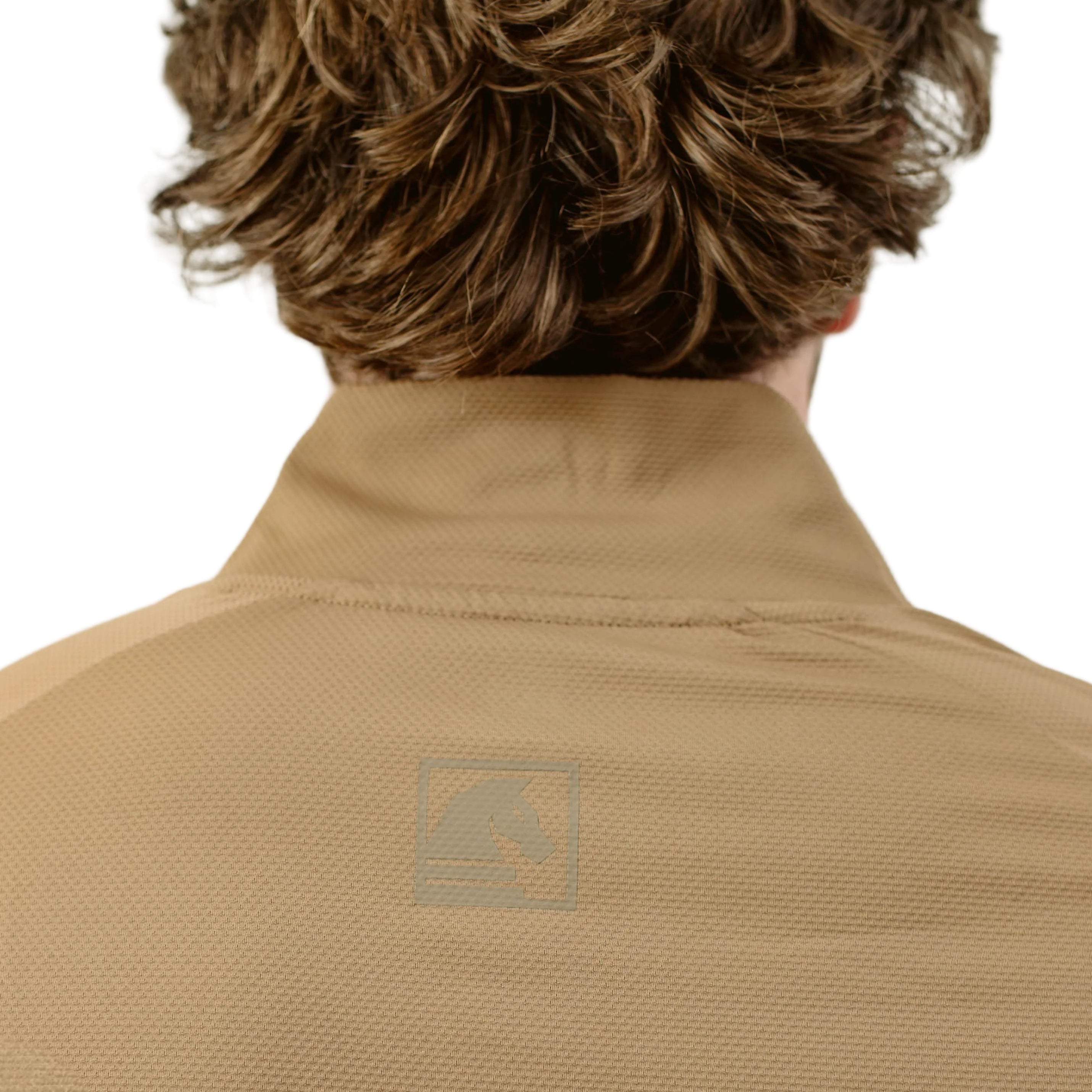 Close up of TD OSS Top Short Sleeve in Coyote showing raglan seam articulation, tonal branding, and reinforced wrap panels, lightweight tactical base layer engineered for range training and field operations