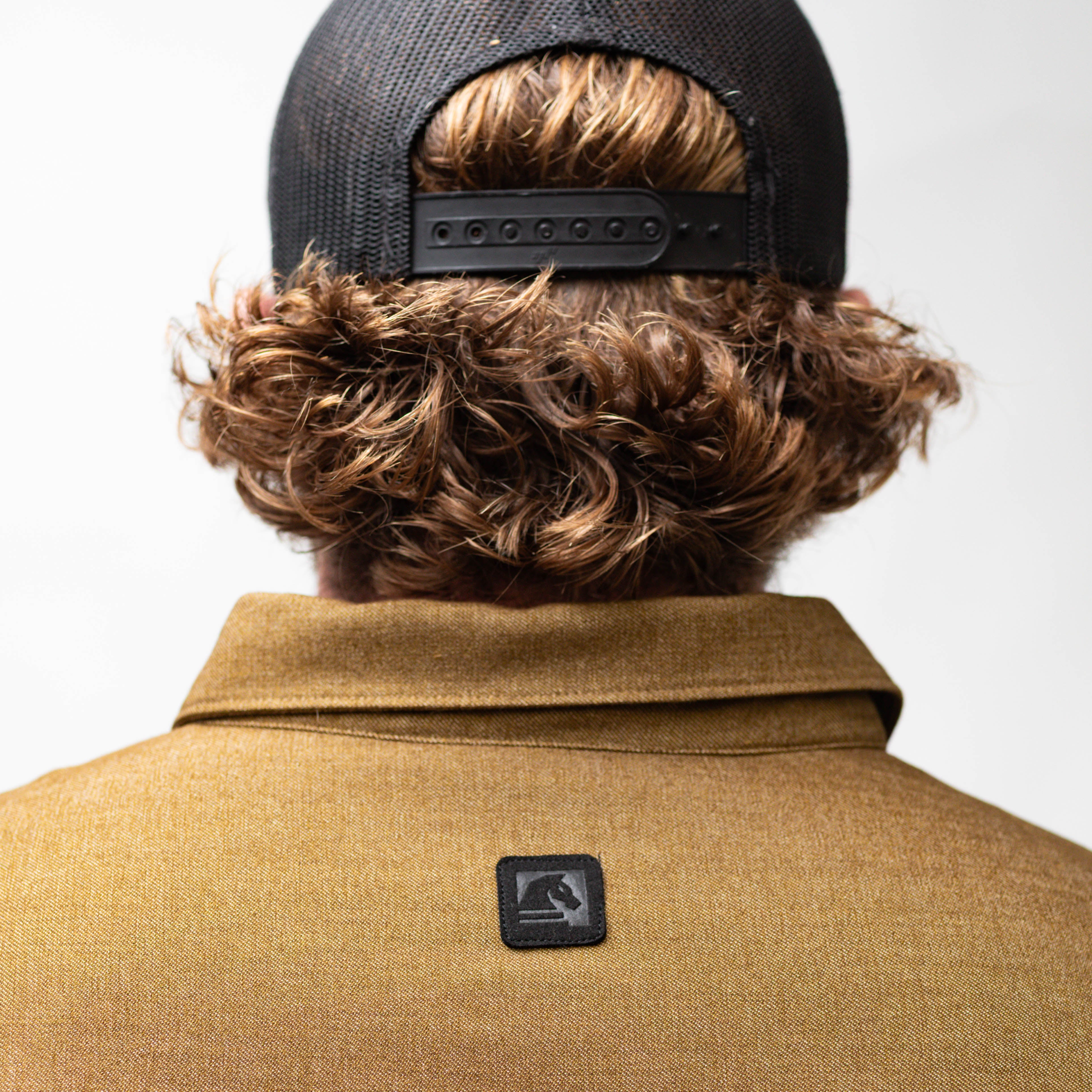 Close-up of the brass TD Stretch Flannel Work Shirt back collar with TD branding, a soft and comfortable collared tactical flannel built for Range Day and durable work apparel.