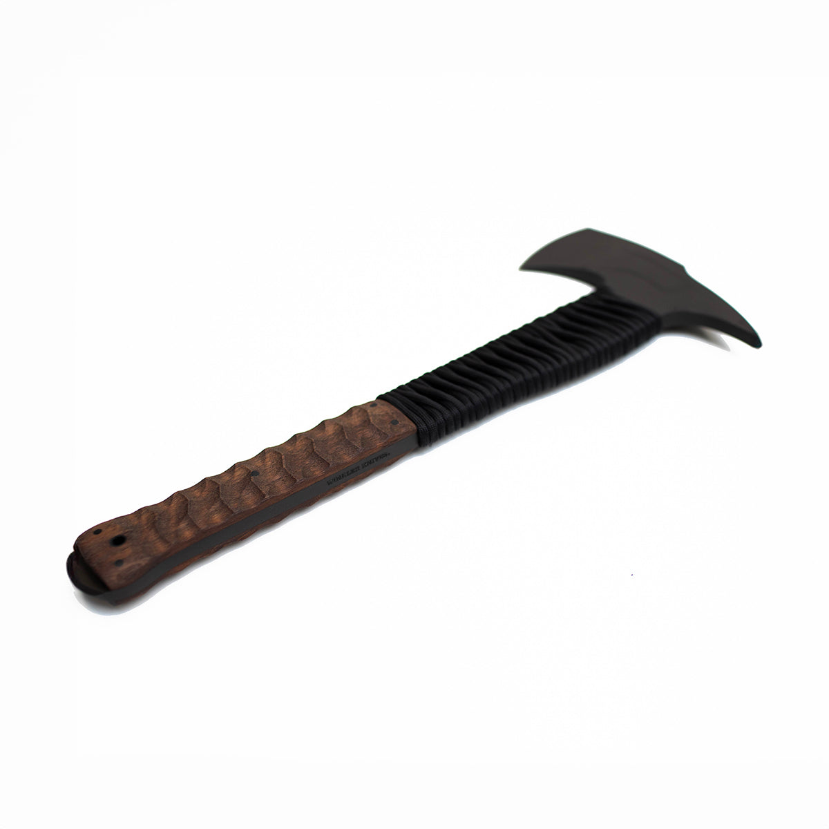 Action-ready WK Combat Axe with walnut cord sculpted handle, designed for military and law enforcement breaching and close quarters use.