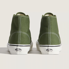 Green high-top sneakers with white soles on a light gray background