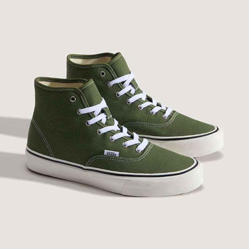 Green high-top sneakers with white laces on a light gray background