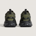 Pair of green and black sneakers on a light gray background