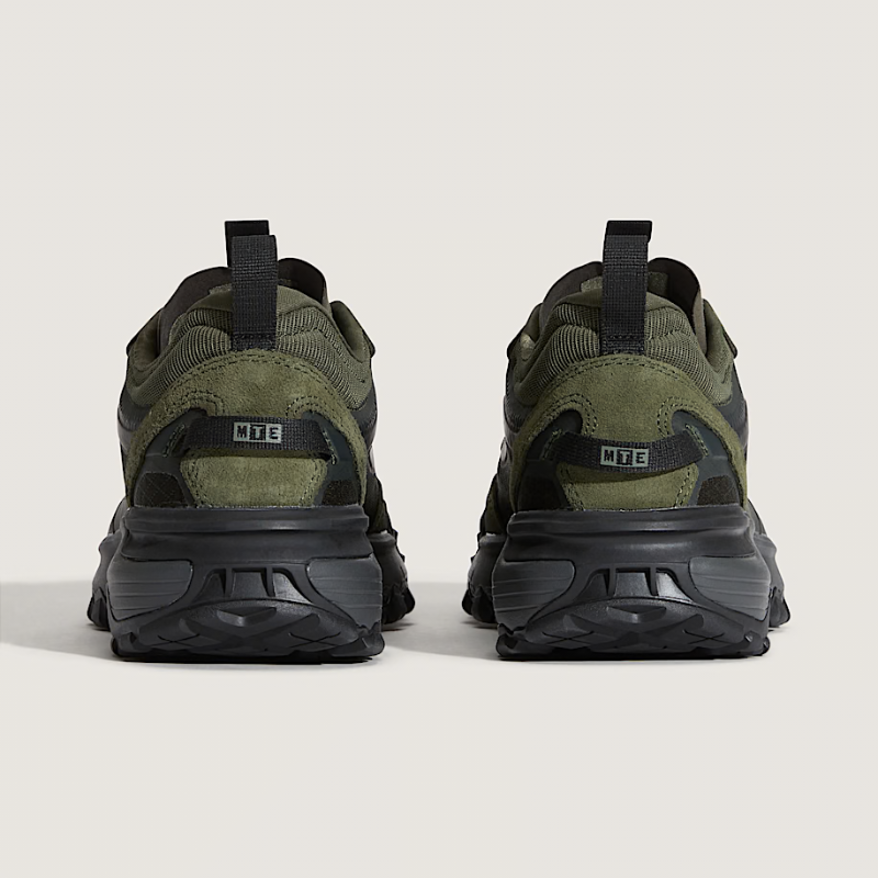 Pair of green and black sneakers on a light gray background