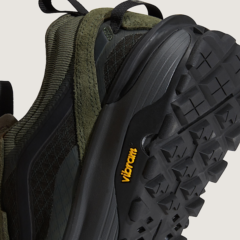 Close-up of a green hiking shoe with Vibram sole on a white background