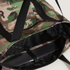 Camouflage duffel bag with a laptop inside on a white background