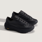 Pair of black sneakers on a light gray background