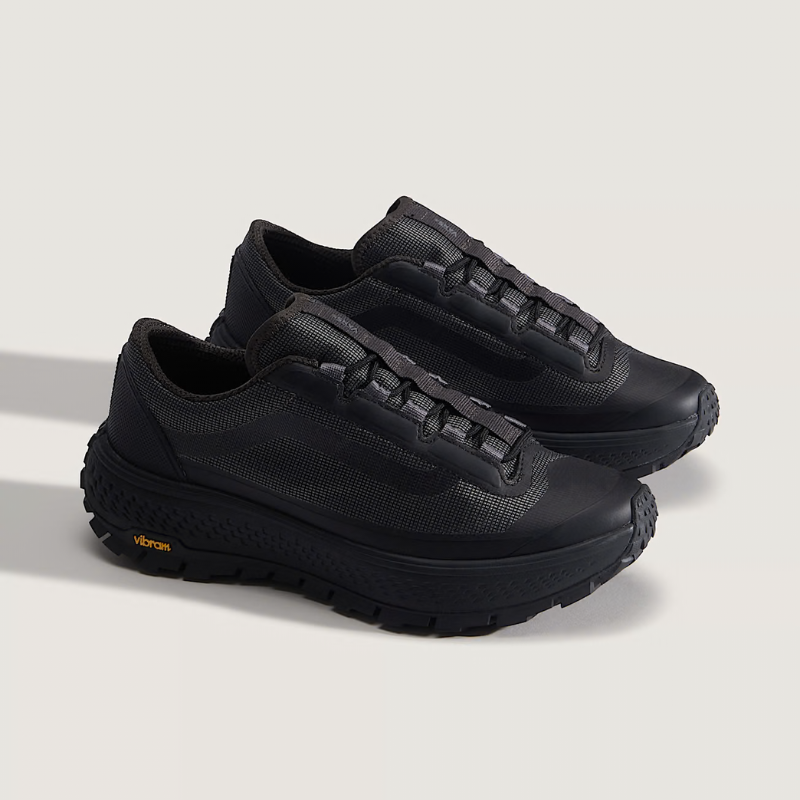 Pair of black sneakers on a light gray background