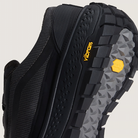 Close-up of a black hiking shoe with Vibram sole on a light gray background
