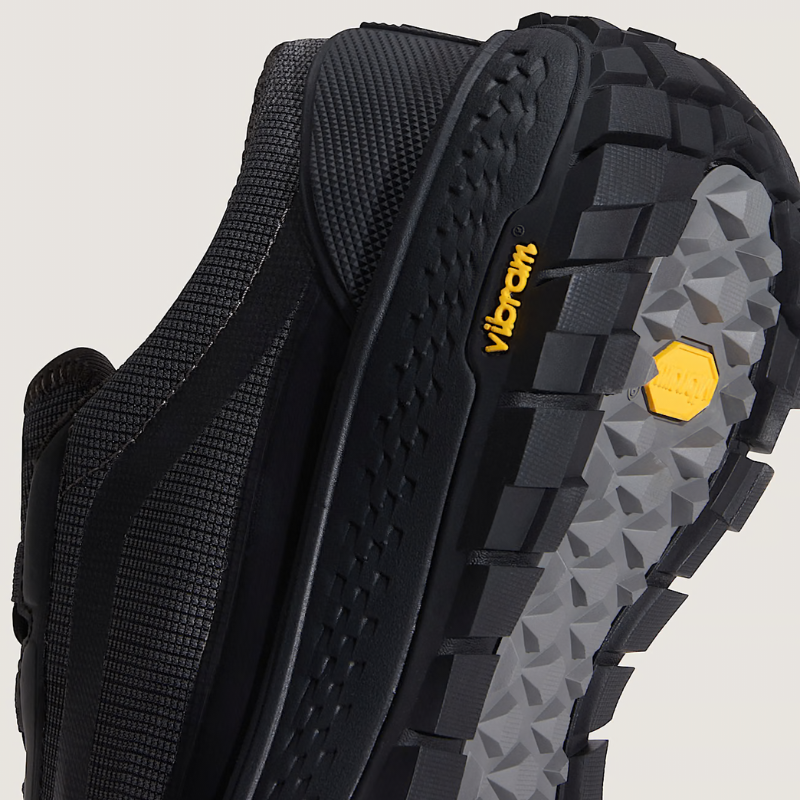Close-up of a black hiking shoe with Vibram sole on a light gray background