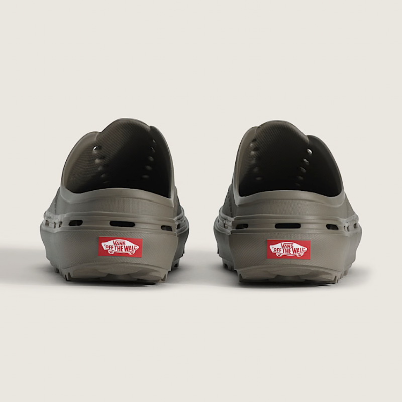 Two gray shoes with red Vans labels on a light gray background