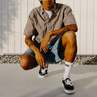 Model wearing Vans Authentic Shoes in Black and White, showcasing the versatile low-top silhouette and everyday casual style.