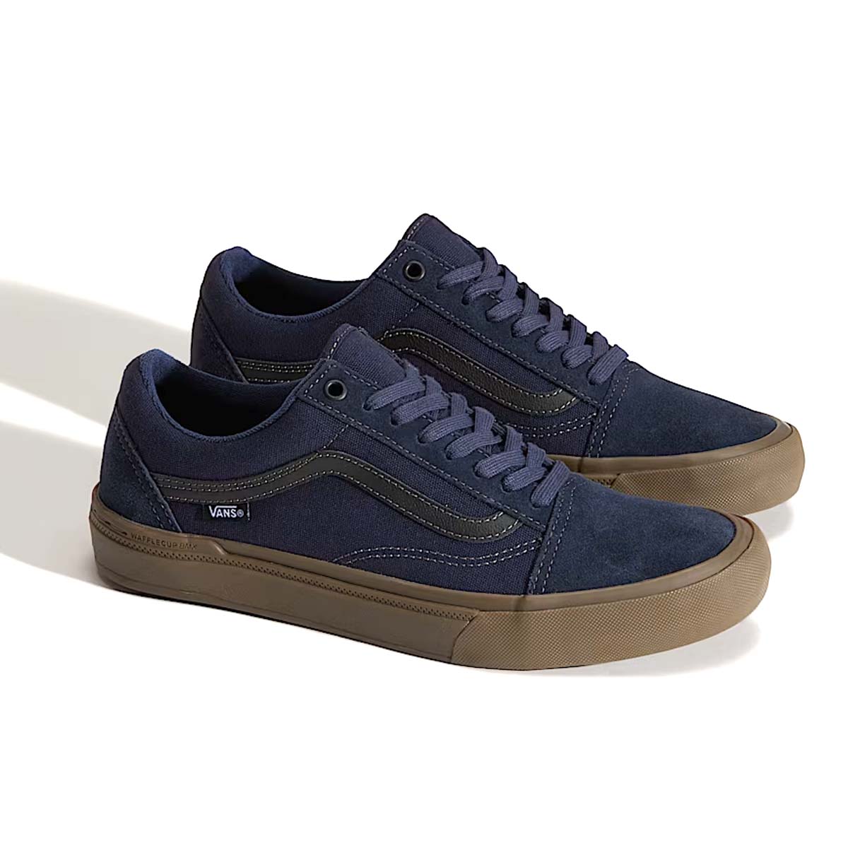 Product shot of the Vans BMX Old Skool Parisian Night colorway shown as a pair, deep blue suede and canvas low-top BMX shoes with gum soles. Built with Wafflecup™ technology for pedal feel, DURACAP™ reinforcements for high-wear durability, and PopCush™ cushioning for impact protection, making them ideal BMX and flat pedal MTB shoes.