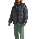 Lifestyle view of the Vans Hillgate Puffer Jacket in Black being worn showing the hooded insulated construction with 10 oz poly fill and recycled polyester shell for cold weather comfort and everyday use.