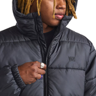 Close up view of the Vans Hillgate Puffer Jacket in Black showing the zipper and Vans logo detailing with 10 oz insulated construction and recycled polyester shell for cold weather performance.
