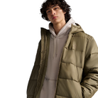 On body view of the Vans Hillgate Puffer Jacket in Bungee Cord brown showing the hooded 10 oz insulated design with a recycled polyester shell built for cold weather comfort, range days, and outdoor missions