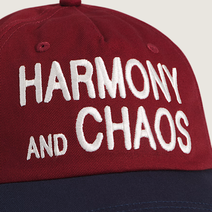 Close-up of the Harmony and Chaos embroidery on the Vans Lakden Snapback Hat, showing direct stitch detail on the front panel in Bordeaux Red and Navy
