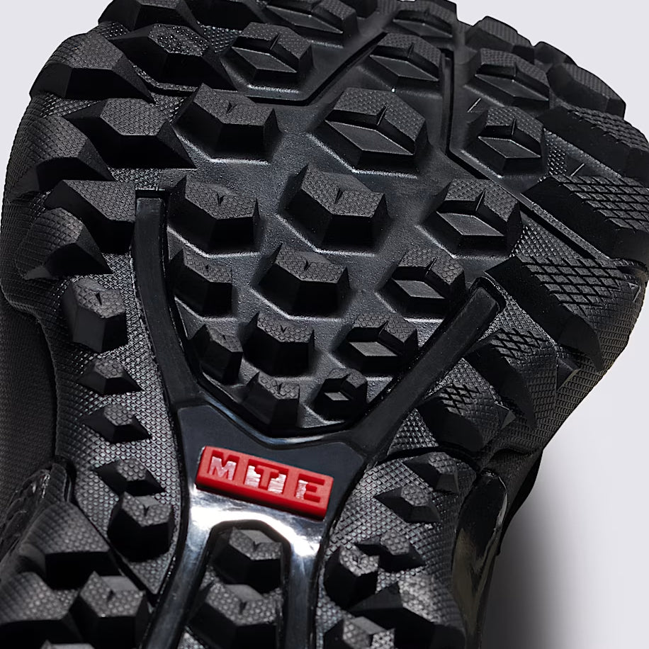 Close up of Vans MTE Crestline ADV Gore-Tex black outsole showing aggressive All-Trac tread pattern and durable rubber compound built for wet terrain traction, hiking grip, and tactical all weather performance