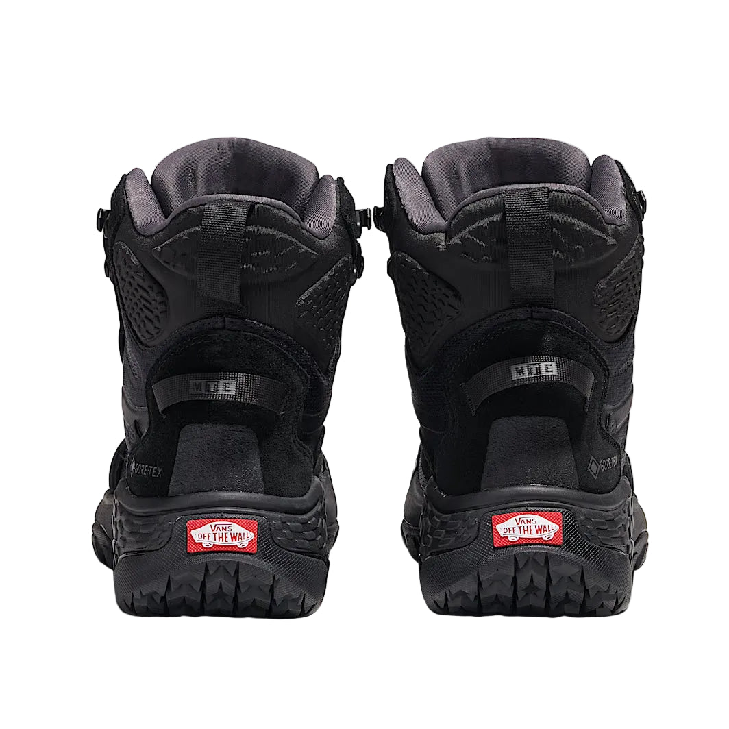 Rear heel view of Vans MTE Crestline ADV Gore-Tex in all black showing reinforced heel counter, mudguard wrap, and high-cut ankle support built for waterproof hiking, tactical field use, and rugged terrain stability