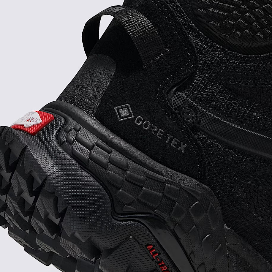 Close up side rear heel of Vans MTE Crestline ADV Gore-Tex in black showing molded heel counter, reinforced mudguard wrap, and durable waterproof upper built for stability on rugged terrain and tactical hiking use