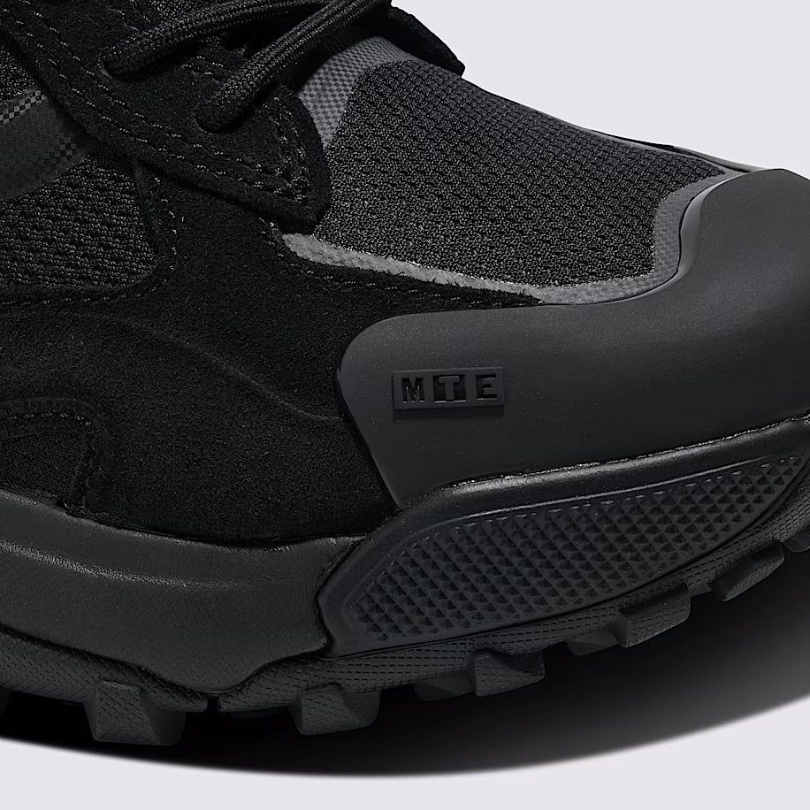 Close up of Vans MTE Crestline ADV Gore-Tex black toe box showing reinforced TPU toe cap, waterproof GORE-TEX upper fabric, and abrasion resistant mudguard built for rugged trail protection and all weather hiking performance