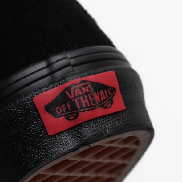 Close-up of the Vans Sk8-Hi in black on black suede showing the iconic “Off The Wall” heel tag. Classic high-top skate shoe with padded collar, reinforced heel, and durable waffle outsole for grip and style.