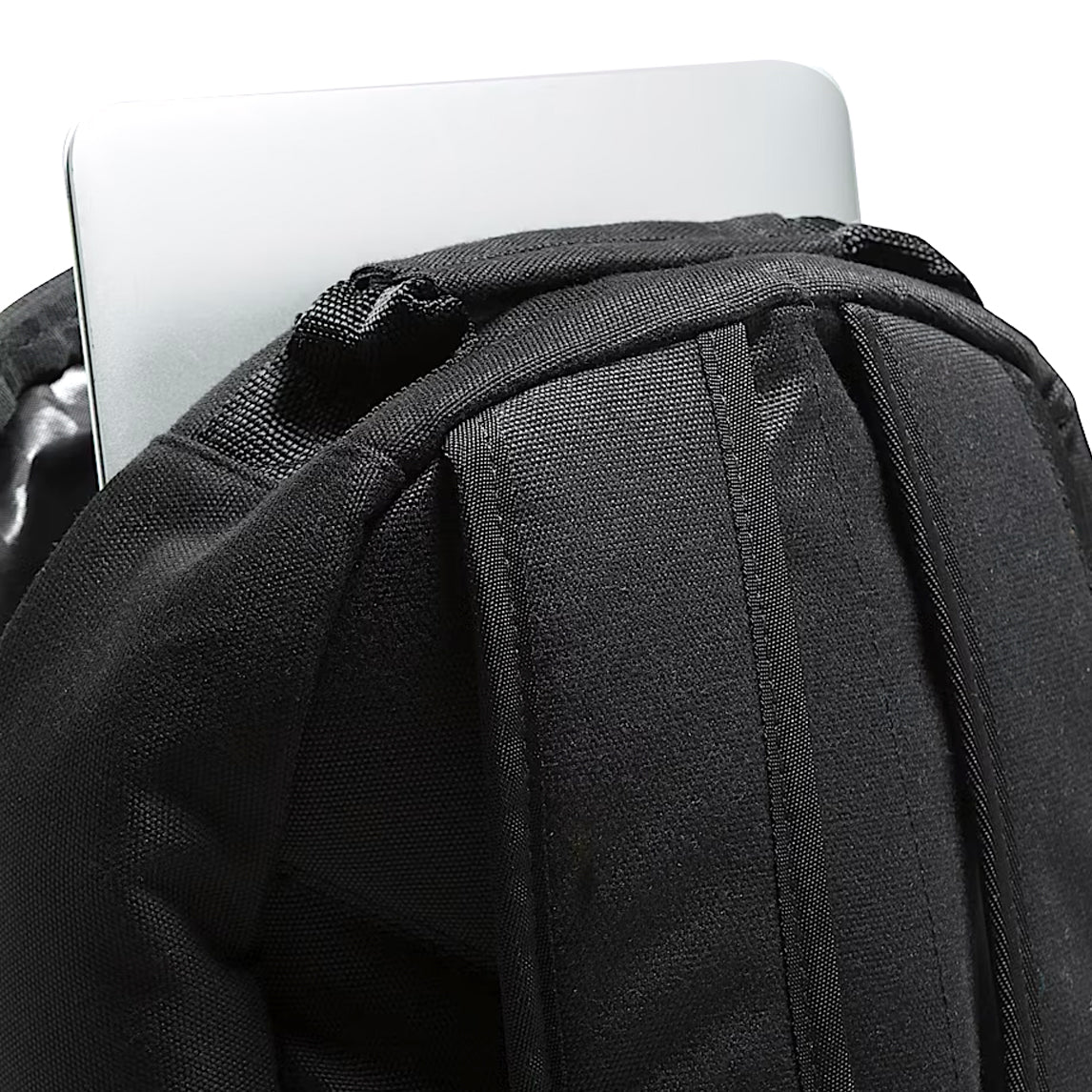 Detail of the black Vans Startle Backpack showing the reinforced top carry handle and padded laptop compartment, built for daily commutes and weekend missions