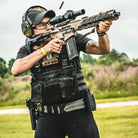 Velocity Systems BOSS Rugby Short Sleeve Combat Shirt worn while shooting at the range. USA-made tactical range top built from 4-way stretch nylon-spandex for mobility, breathability, and comfort in military, LE, and training environments.