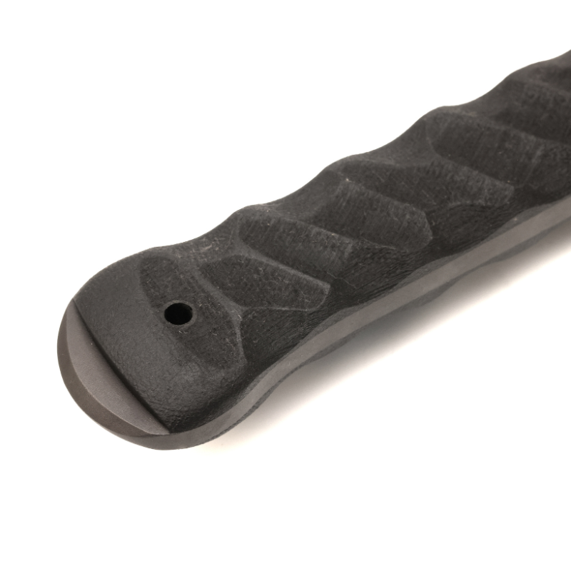 Close-up of a textured black handle on a white background