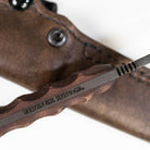 Close up of Winkler Knives maker mark etched on 80CrV2 black oxide fixed blade highlighting American made craftsmanship and tactical field knife construction