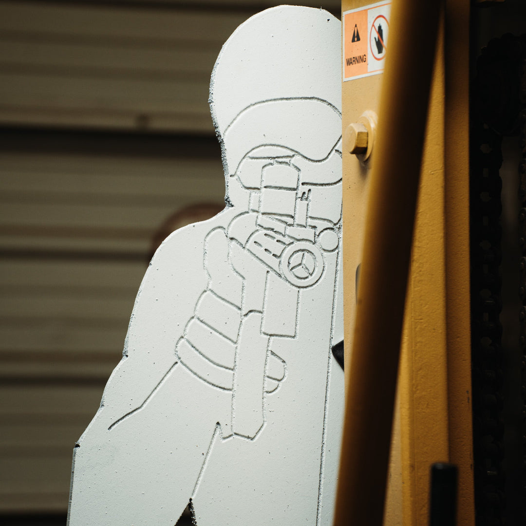 White silhouette target on a yellow background.